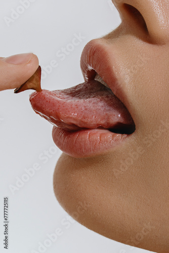 Close-up woman's big plump lips and Mouth With Tongue Sticking Out photo