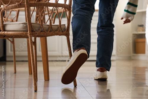 Man tripping over chair in ...