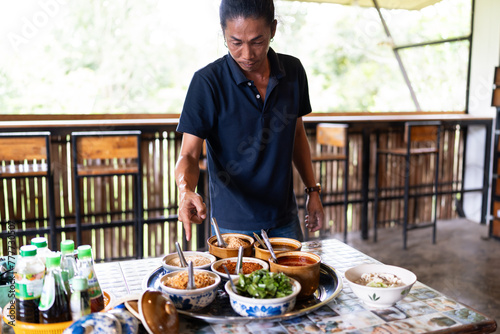Thai man giving cooking instructions. photo