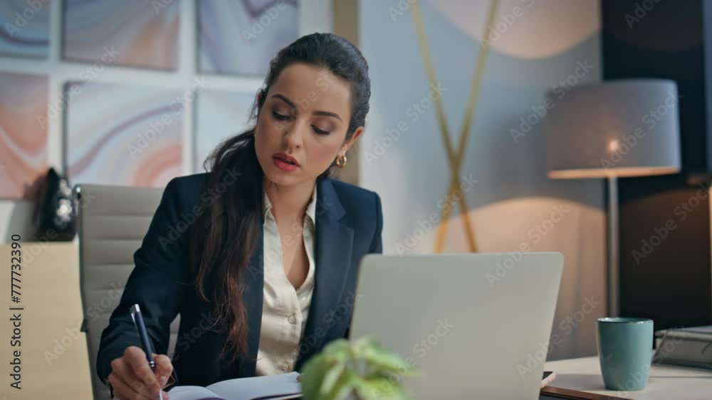 Pensive manager making notes working by laptop closeup. Ceo holding mug writing