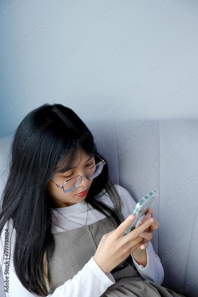 Female Office Worker Looking At Cell Phone Female Office Worker Looking At Cell Phone