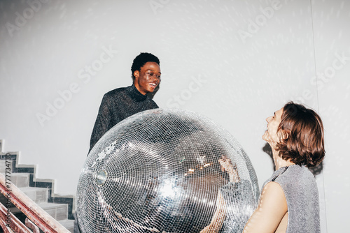 Men with large disco ball