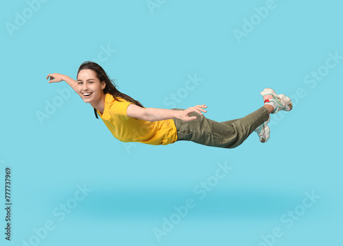 Joyful young woman flying o...