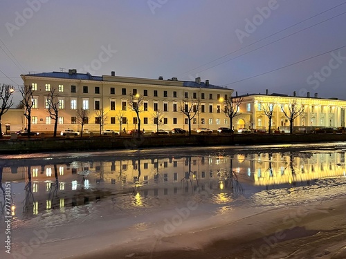 iced city river, city buildings reflection on the iced city river, night illumination  © Oksana