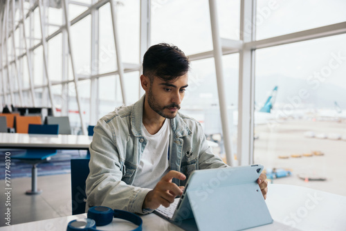 Man using a tablet at the airport