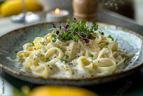 Perfectly cooked fettuccine enveloped in a velvety white sauce, topped with a colorful sprinkle of microgreens.