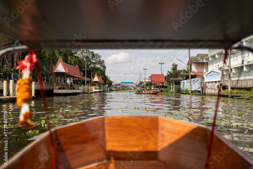 Boat sailing in water canal in Thailand.