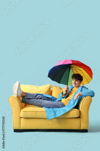 Young man with umbrella lyi...