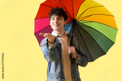 Young man with umbrella on ...