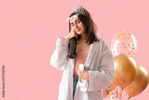 Drunk young woman in robe w...