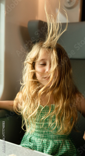 A little girl blowing her hair up photo