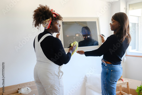 Two women decorating new home 