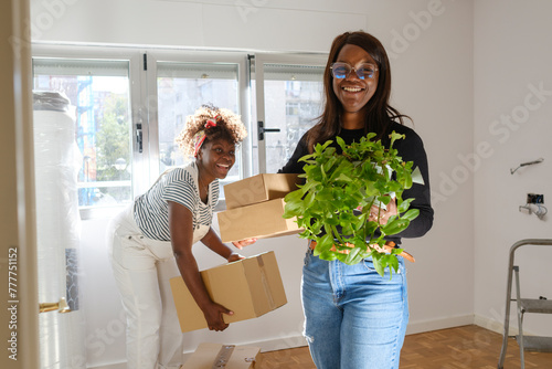 Woman carrying stuff moving out smiling at camera photo