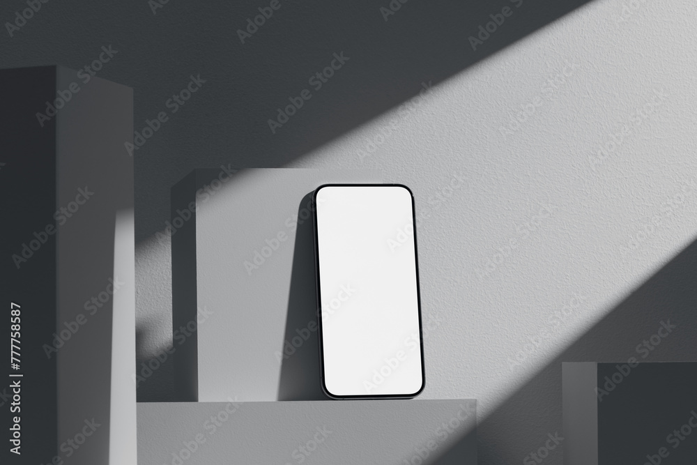 Mobile phone on cube podium for display of app.