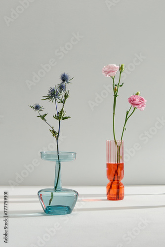 Bouquet of various wildflowers in a glass vase with water photo