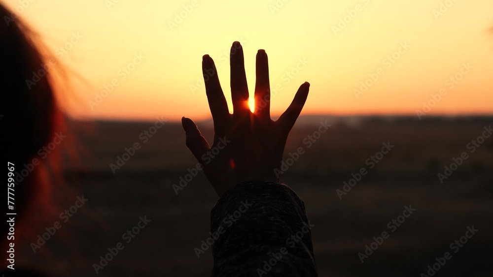 girl sunlight symbol, hand sun rays, sunbeam through fingers, dreamy sunset silhouette, prayer hope dusk, faith hand gesture, looking into light, sunset peace calm, spiritual sun worship, reflective