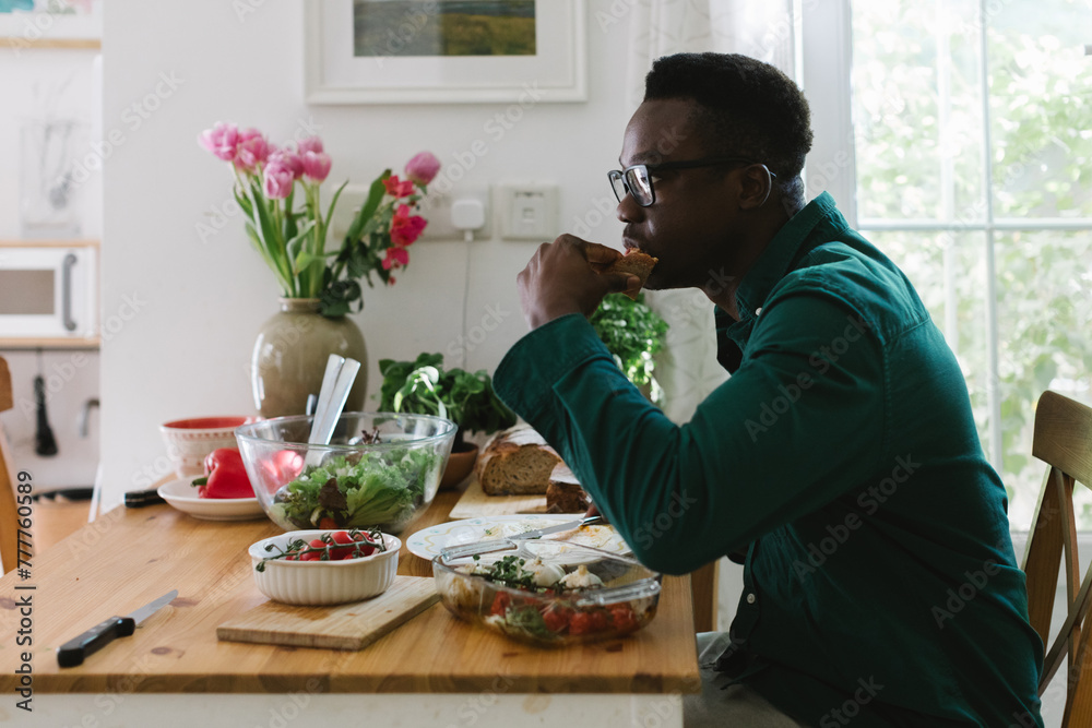A man is eating breakfastat home A man is eating breakfastat home