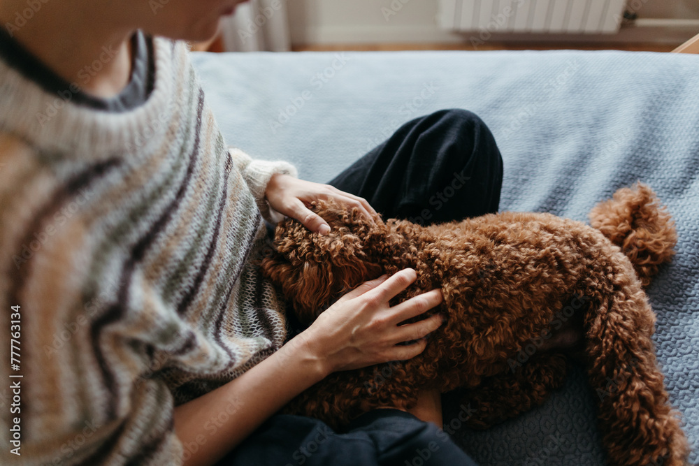 Female sitting with dog at home. Female sitting with dog at home.
