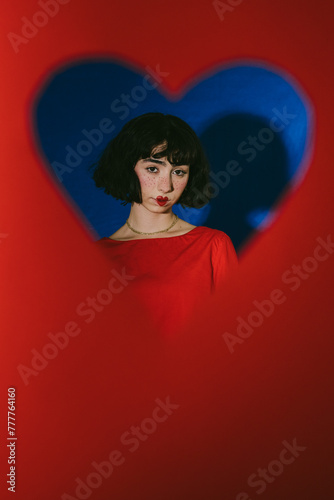 Portrait of a person Looking Though A Red Heart Shape photo