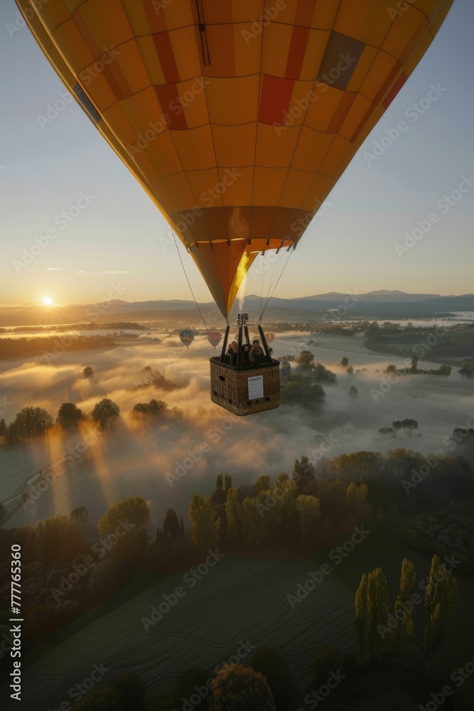 A hot air balloon flying over a field with fog in the background. Generative AI.