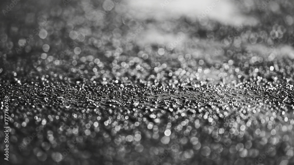 Sparkling water droplets on monochrome texture. Black and white photography of water drops. Artistic interpretation of rain on surface. Sparkling water droplets on monochrome texture. Black and white photography of water drops. Artistic interpretation of rain on surface.