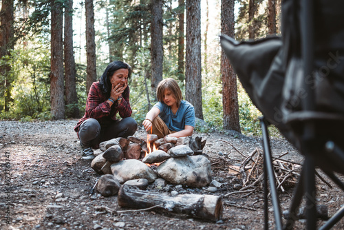 mother and son making campfire photo