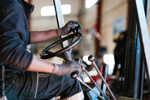 Crop worker driving industrial truck at factory photo