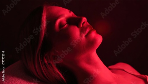 Serene woman enjoying a tranquil red-light therapy session. The gentle glow bathes the subject in a calming, therapeutic radiance.