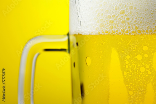 A close-up of a mug of beer with a yellow background