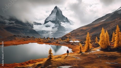 Scenery moody of Nublet peak with mount Assiniboine and hiker standing photo