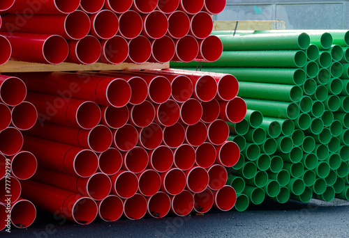 Plastic ducts stacked for underground cables at construction site photo