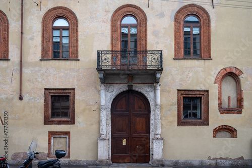 Old house with balcony and motor bike on rainy day in Milan, Italy and motor bike on rainy day in Milan, Italy