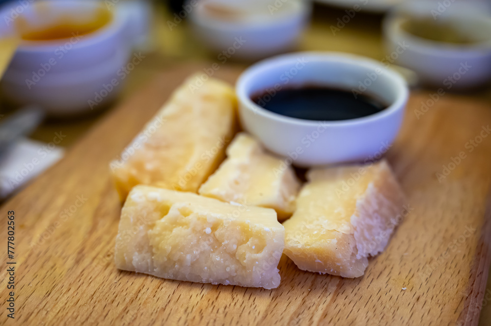 Tasting of different matured and very old parmesan Italian Parmigiano-Reggiano hard cheese and balsamic vinegar Modena in Parma, Emilia Romagna, Italy