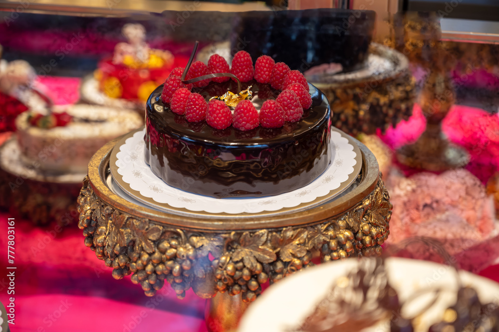 Italian sweet dessert pastry dolce and cakes with cream and fruits on display in artisanal bakery in Milan, Italy