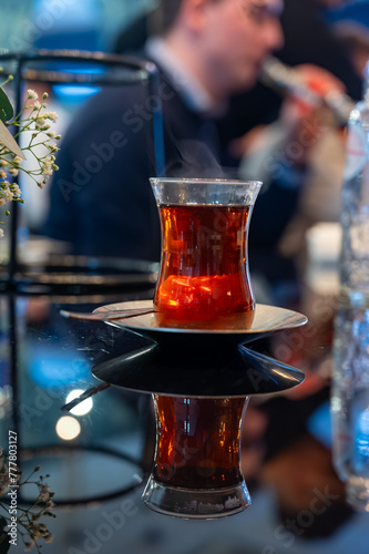 Turkish sweet tea served in traditional glass in restaurant in Istanbul, Turkey photo
