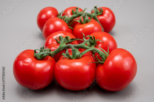 Red ripe tasty Dutch tomatoes growing indoor in greenhouse all seasons, food industry in Netherlands close up © barmalini