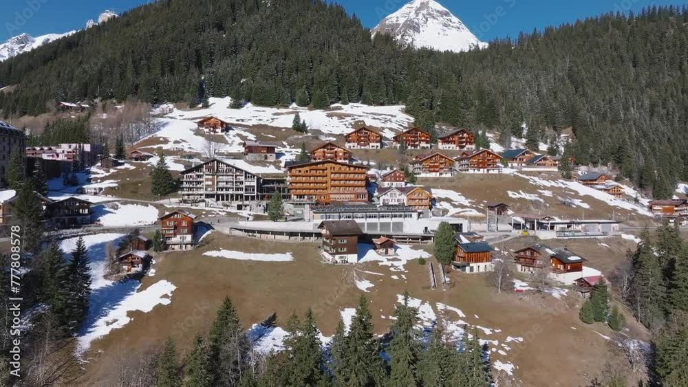 Beautiful panoramic aerial view of the Murren ski resort town in Switzerland. Luxury hotels and buildings located on the edge of the cliff. Beautiful panoramic aerial view of the Murren ski resort town in Switzerland. Luxury hotels and buildings located on the edge of the cliff.