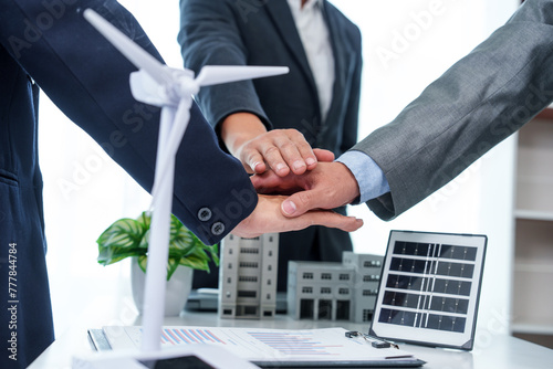 Two business executives, elegantly attired in suits, join hands in a gesture of unity, solidarity, and shared commitment towards a common goal or venture.