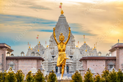 Statue of Nilkanth Varni with Akshardham Mahamandir temple in the back photo