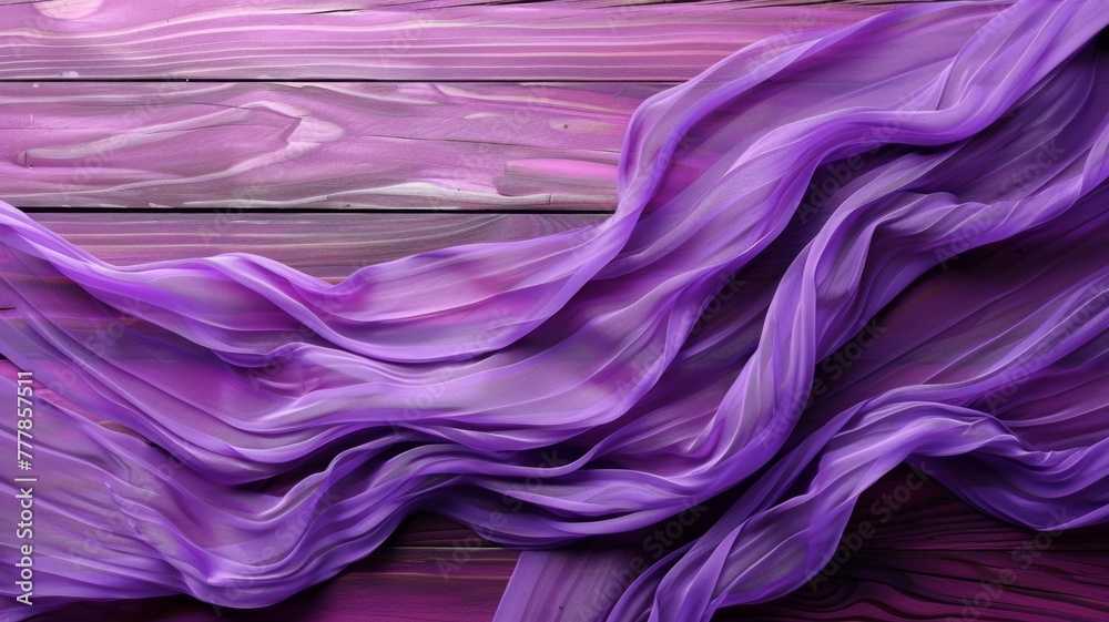 Obraz premium Vibrant purple drapery on wooden background - A high-resolution image showcasing a fluid purple fabric against a textured wooden surface, creating a luxurious feel