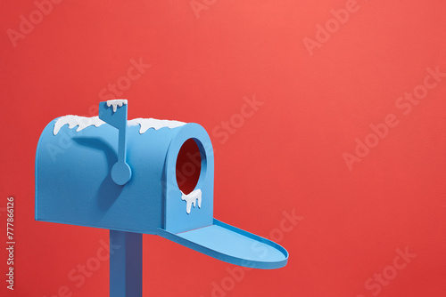 Open a blue letter box isolated on red in snow