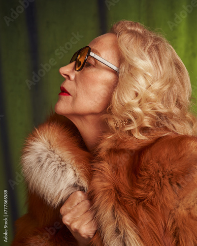 Senior beautiful woman in vintage style wearing a fur coat. photo