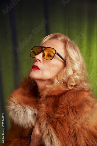 Senior beautiful woman in vintage style wearing a fur coat. photo