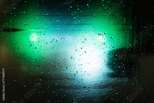 Green and blue lights on a rainy night photo