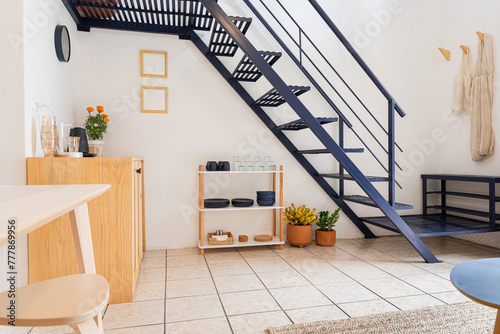 Beautiful apartment with stairs on the first floor and decorations photo