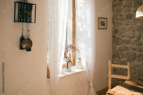 French windows with morning light and dried bouquet photo