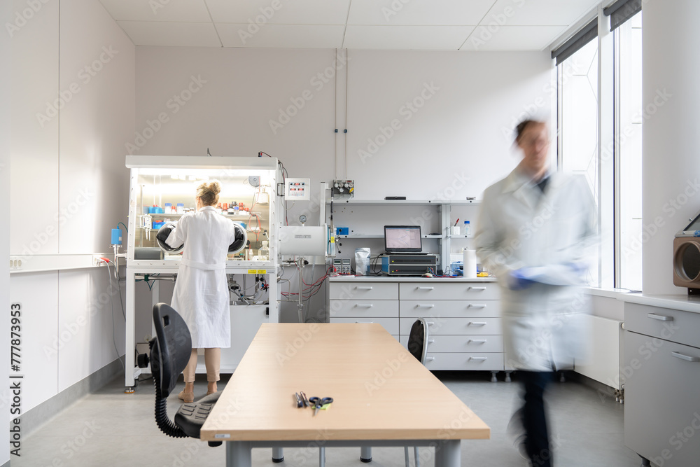 Scientists Working In Modern Lab 