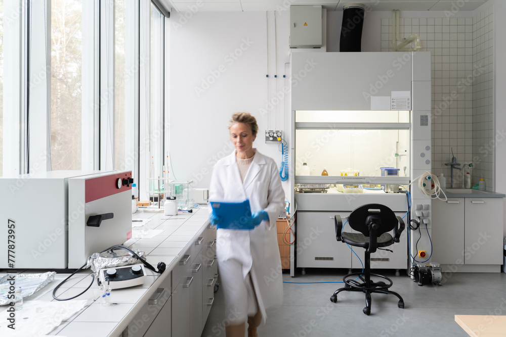 Female Scientist Walking In Modern Lab 