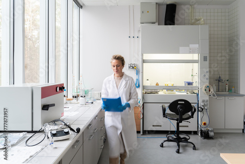 Female Scientist Walking In Modern Lab 