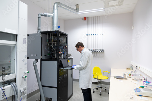 Researcher Using Atomic Layer Deposition Device. photo